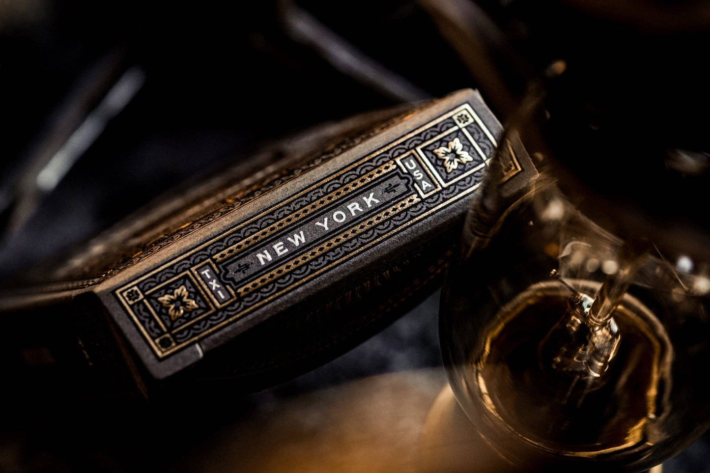 Close up of a decorative playing cards box on a dark background.