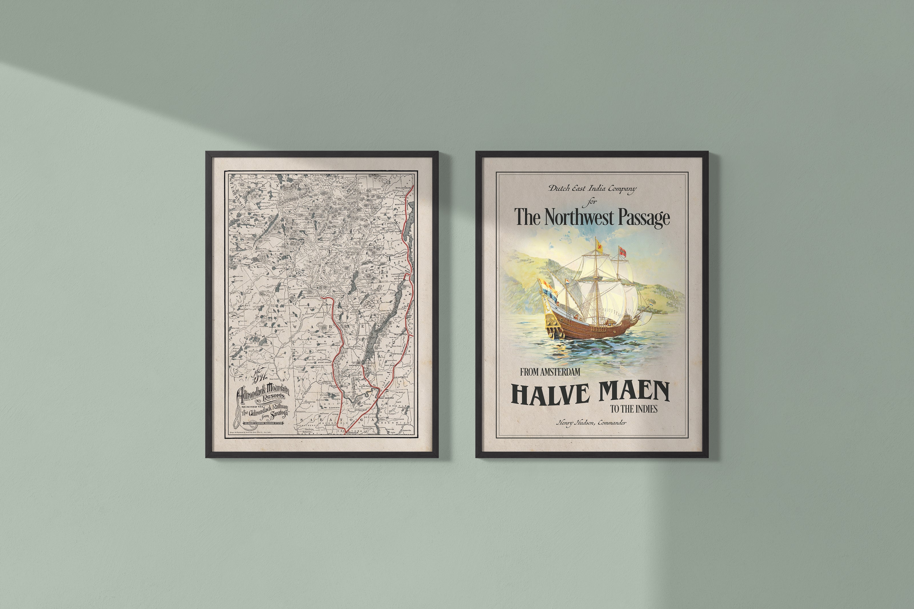 Two framed maps or posters on a muted sage wall.