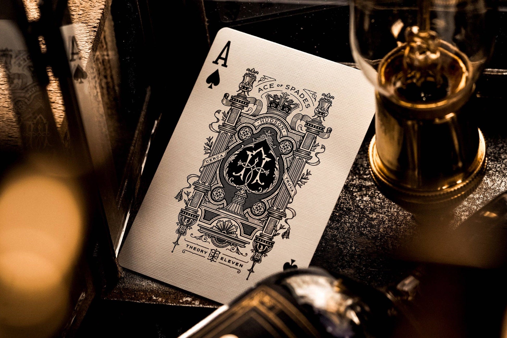 Playing card with a black and white design on a dark surface.
